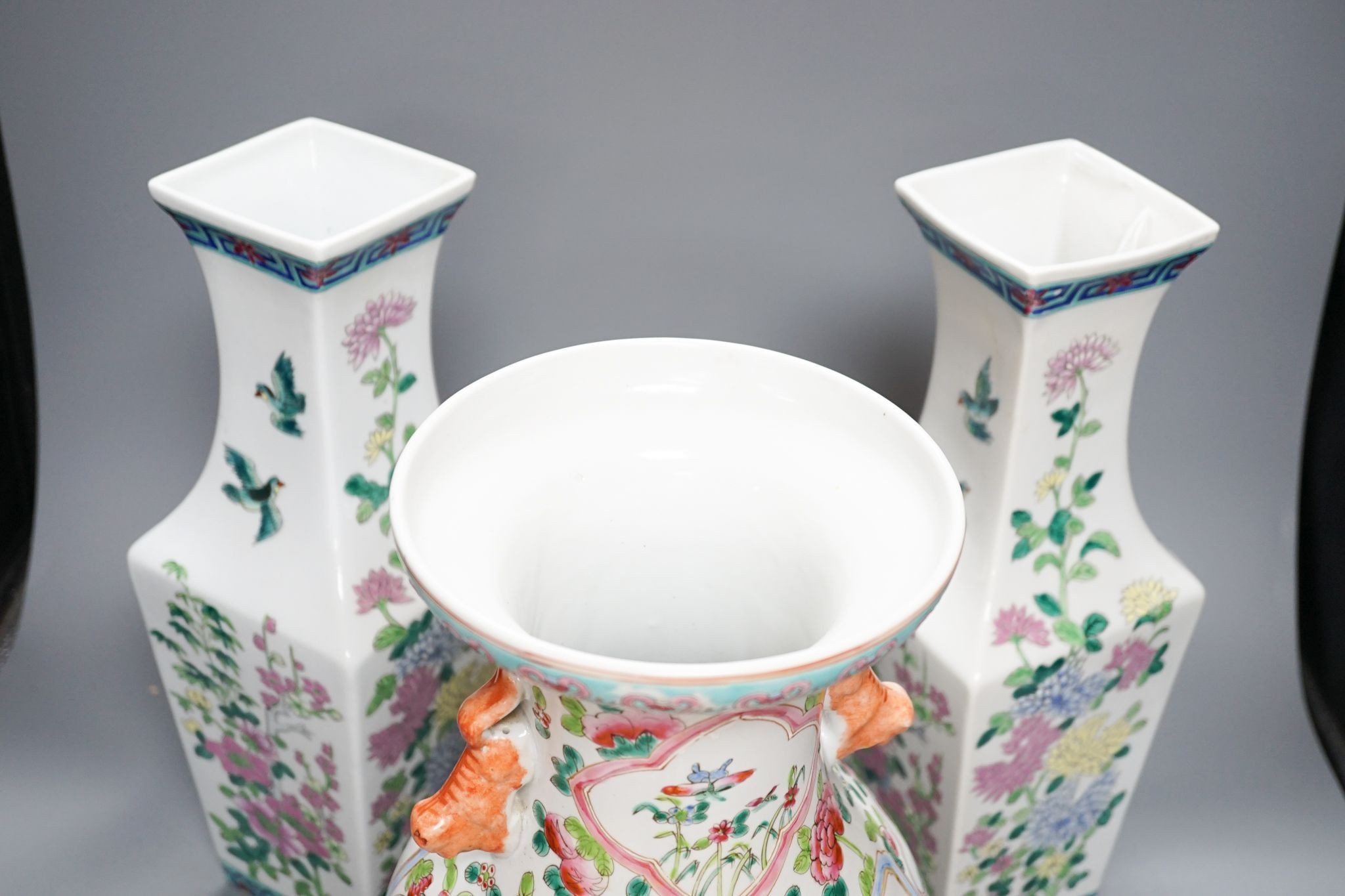 A pair of Chinese famille rose square baluster vases, and another famille rose vase, 37cm